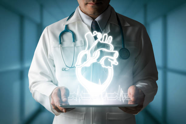 Medical Concept - Doctor showing heart hologram generated from tablet computer.